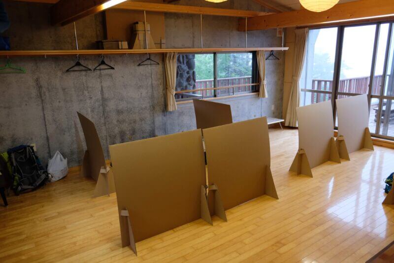 段ボールのパーテーションで区切られた大部屋の様子。